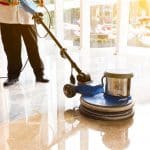 people polish the floor indoors