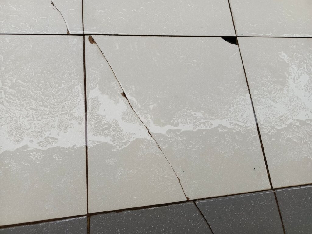 What causes a crack in tile and how can you fix it?